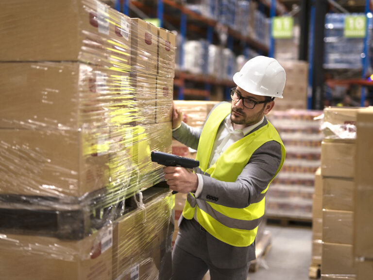 warehouse worker scanning boxes in warehouse
